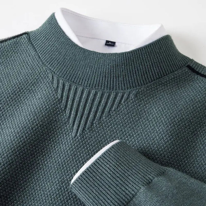 Aavelise Orion textured knit sweater featuring a cozy, patterned design in neutral tones, displayed on a hanger.