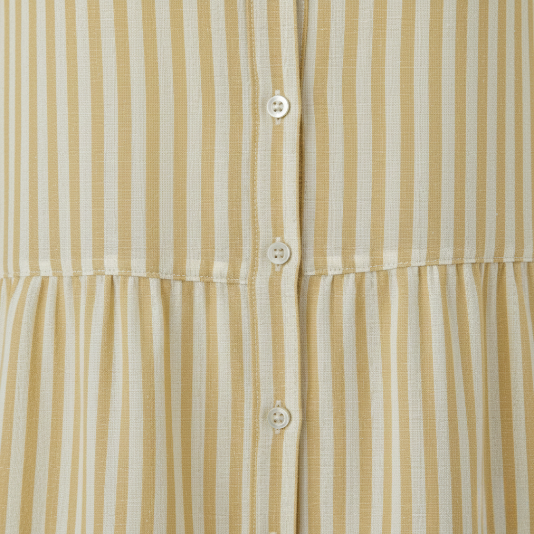  yellow striped shirt dress in a close-up details with a turn-down collar and flowing skirt, ideal for casual gatherings in warm weather.
