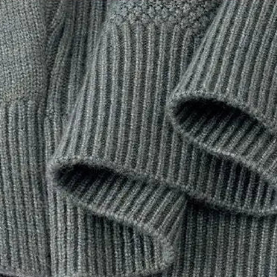 Avelise The Orion textured knit sweater featuring a close-up of the cozy, patterned fabric in neutral tones.