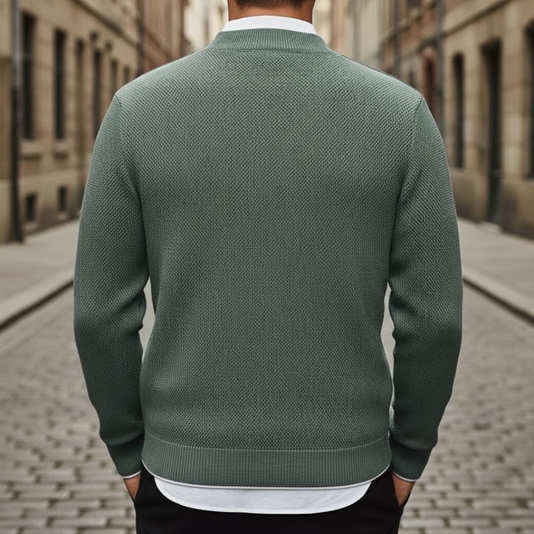 A close-up of the Avelise Orion textured knit sweater showing its detailed pattern and cozy fabric in a neutral color.