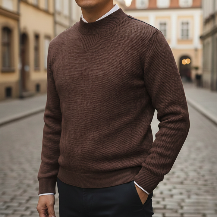 A close-up of the Avelise Orion textured knit sweater showing its detailed woven pattern and cozy fabric in natural light.