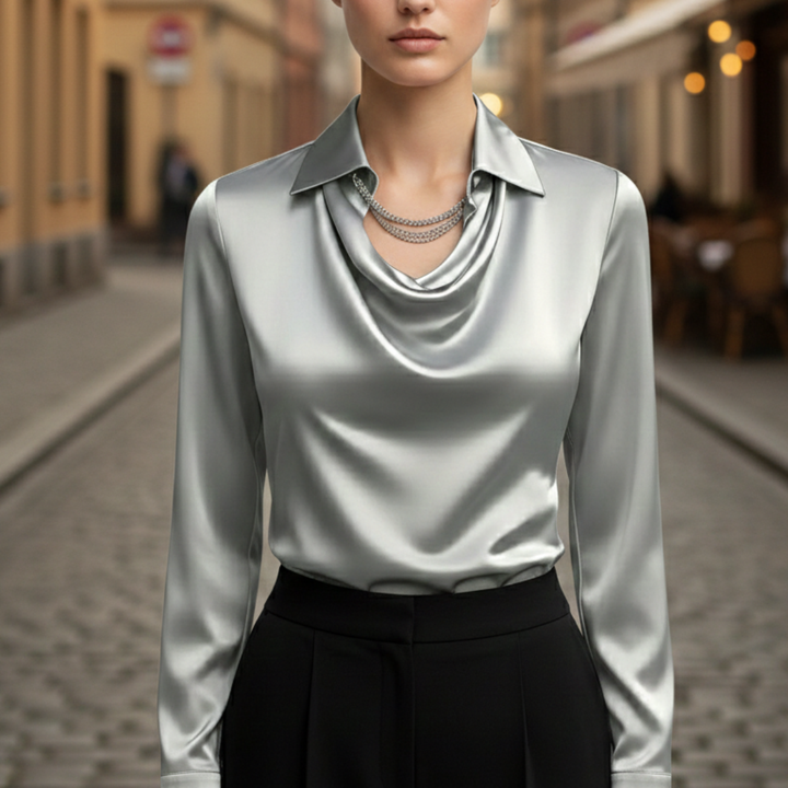 Silver satin blouse for women with a turn-down collar, draped front, and long sleeves.